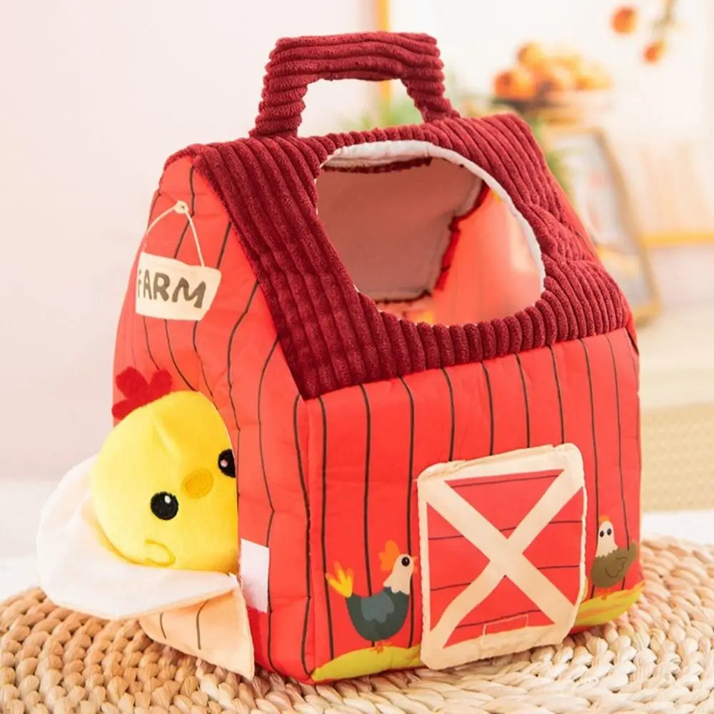 Red barn-shaped toy with a duckling on a woven surface